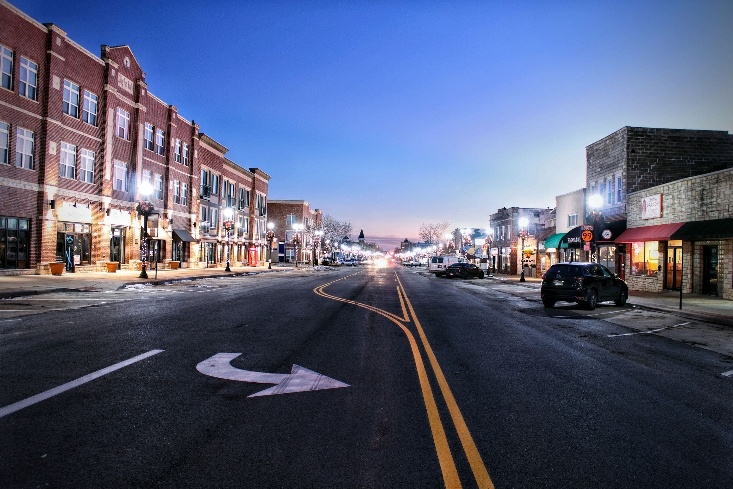 A brick main street at dusk, the kind of city street we serve for towing in Moose Jaw, SK