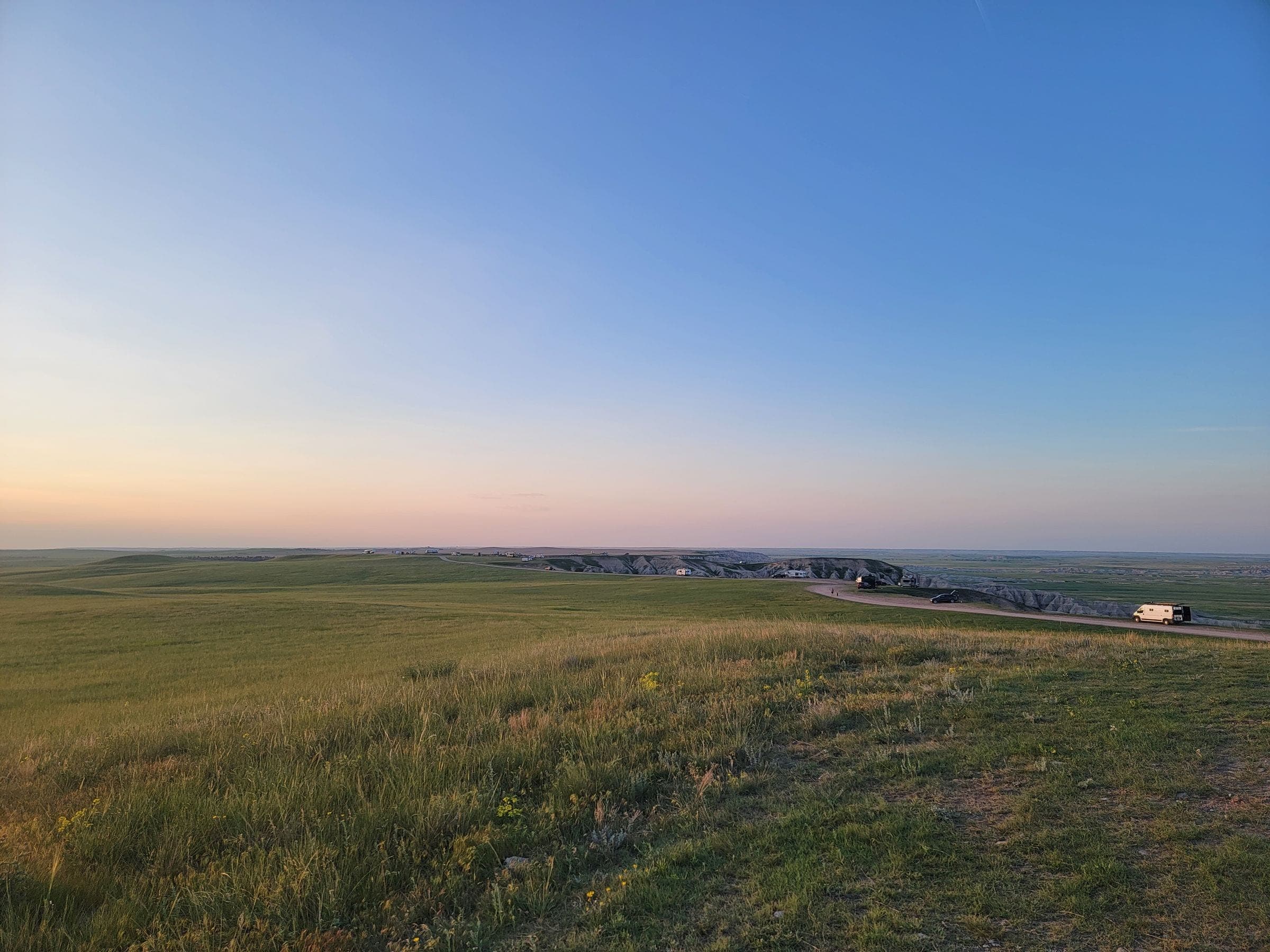 Flat green prairie at sunset, the kind of country we serve for towing in Pilot Butte, SK